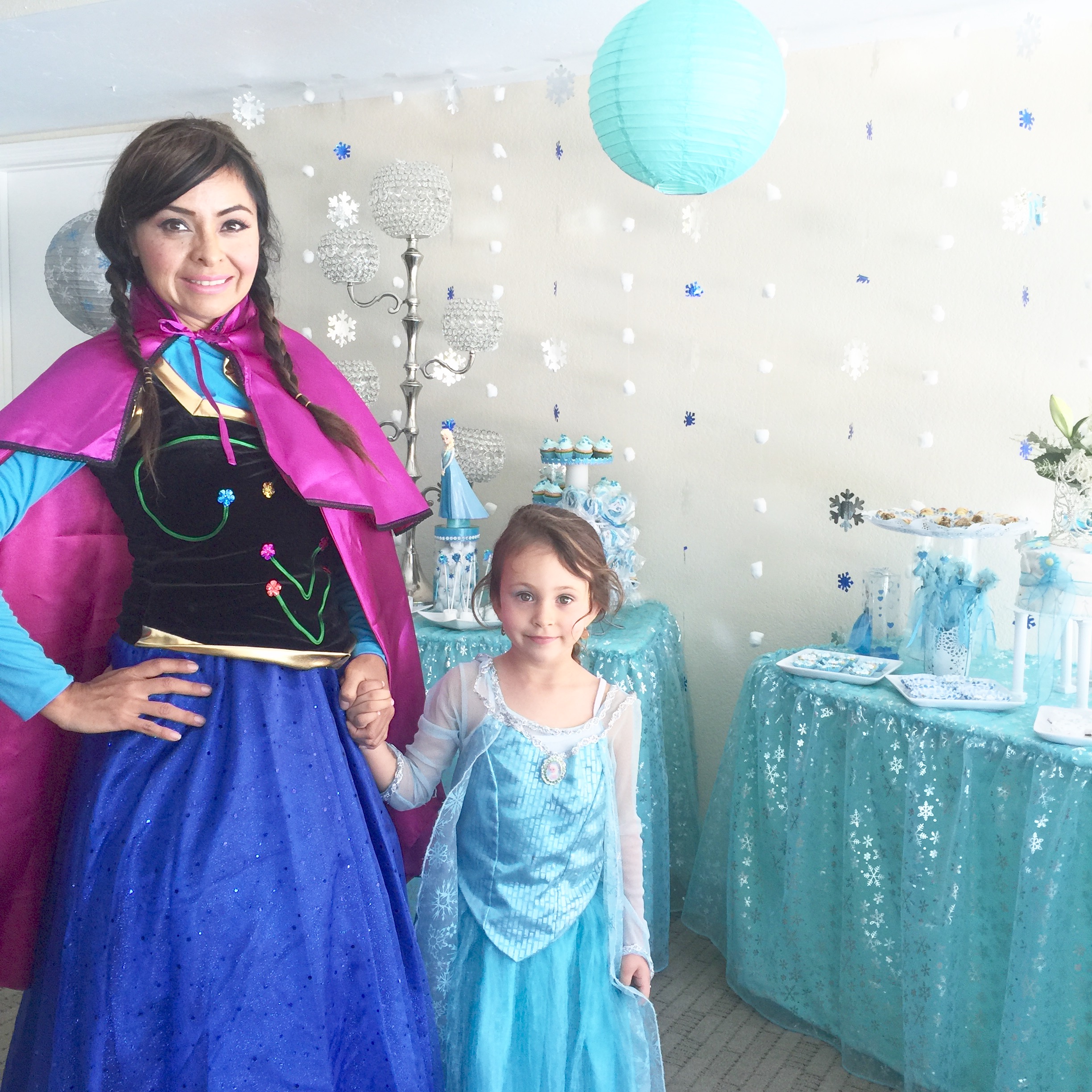 Daniela and her daughter in Frozen costumes at a party