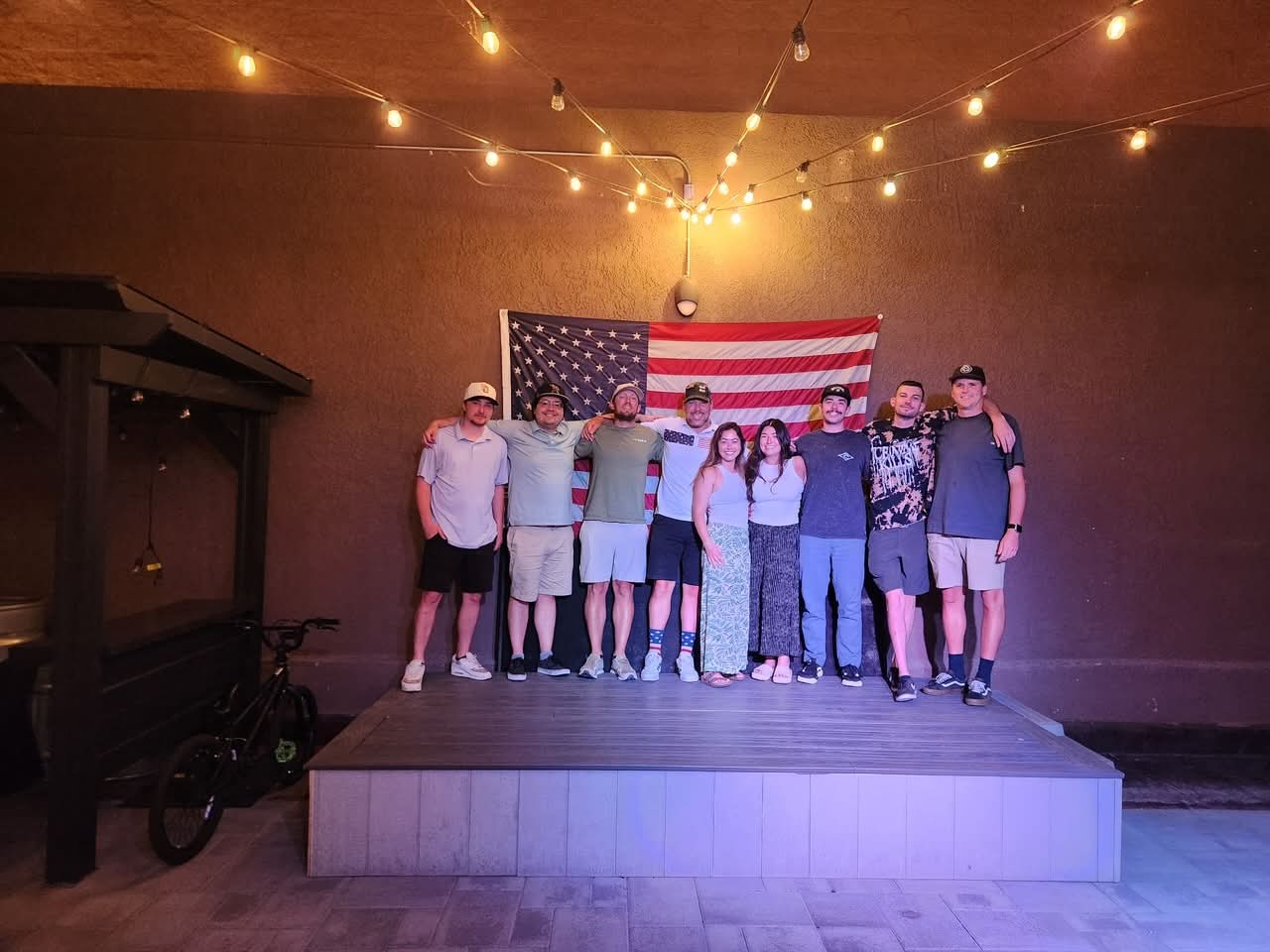 Jason and supporters beneath the American flag