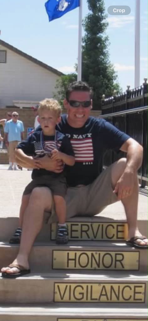 Jason Bennett with his son beneath the American flag